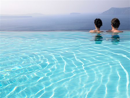 santorini island greece and people - Couple in swimming pool Stock Photo - Premium Royalty-Free, Code: 649-02054253