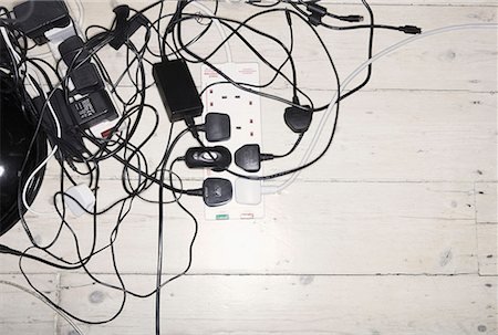plug - Tangled mess of power leads and chargers Stock Photo - Premium Royalty-Free, Code: 649-02054429