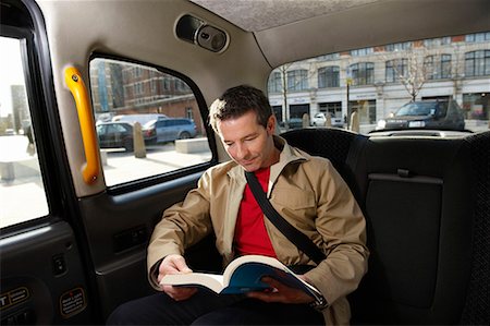 Man reading in London Taxi Fotografie stock - Premium Royalty-Free, Codice: 649-02054563