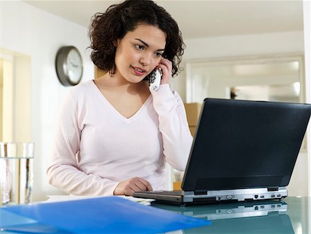 simsearch:649-03882419,k - Woman on phone with laptop Stock Photo - Premium Royalty-Free, Code: 649-02055155