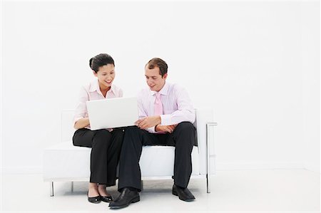 email white background - Man and woman smiling at laptop Stock Photo - Premium Royalty-Free, Code: 649-02055290