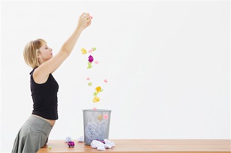 Woman drops paper into bin Stock Photo - Premium Royalty-Free, Code: 649-02055324