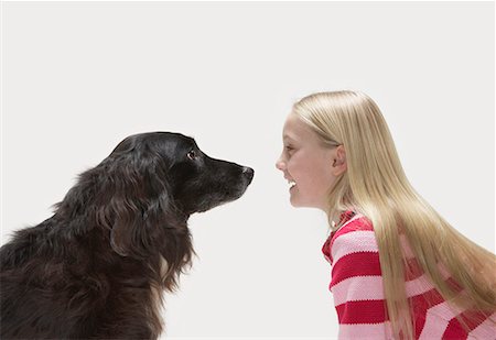 dog smile studio - Portrait of girl looking at dog Stock Photo - Premium Royalty-Free, Code: 649-02055503