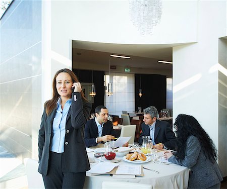 Businesswoman on phone during meeting Stock Photo - Premium Royalty-Free, Code: 649-02053768