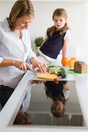 Mother preparing sandwich for daughter Stock Photo - Premium Royalty-Free, Code: 649-02053936