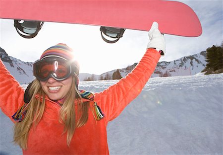 snowboarder (female) - Girl lifting ski board, smiling Stock Photo - Premium Royalty-Free, Code: 649-02198701