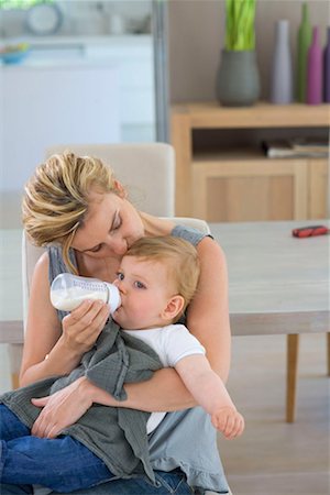 Mother kisses and bottle feeds baby Stock Photo - Premium Royalty-Free, Code: 649-02198728