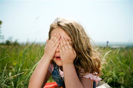eyes covered - Girl hiding behind hands Stock Photo - Premium Royalty-Free, Code: 649-02198883
