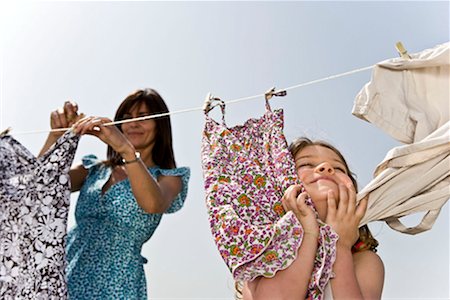 family wind energy - Girl rubbing clothes on face Stock Photo - Premium Royalty-Free, Code: 649-02198890