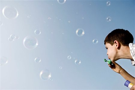 future vision - Boy blowing bubbles Stock Photo - Premium Royalty-Free, Code: 649-02198921