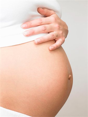 simsearch:614-08726746,k - Pregnant woman touching her belly Foto de stock - Royalty Free Premium, Número: 649-02198986