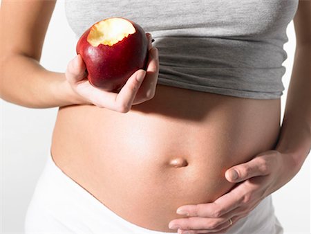 Pregnant woman with an apple Stock Photo - Premium Royalty-Free, Code: 649-02198988