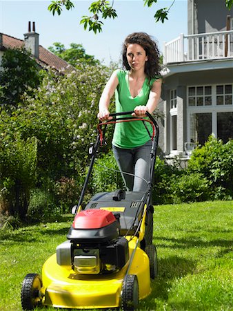 Woman mowing lawn in the sun Stock Photo - Premium Royalty-Free, Code: 649-02199093