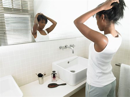 simsearch:649-03666458,k - Woman in bathroom, looking in the mirror Foto de stock - Sin royalties Premium, Código: 649-02199118