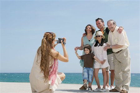 father son grandson back - Mother taking video of family by sea Stock Photo - Premium Royalty-Free, Code: 649-02199255