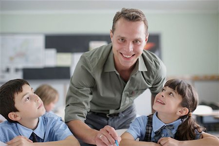 Male teacher correcting student work Stock Photo - Premium Royalty-Free, Code: 649-02199325