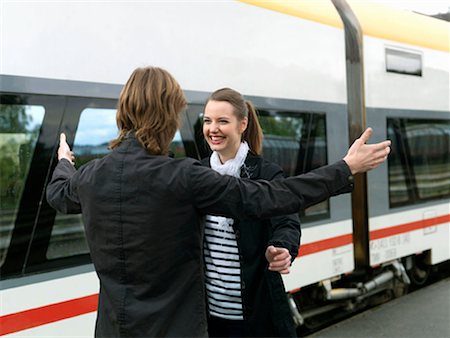 people hugging train station - Young couple on train station Stock Photo - Premium Royalty-Free, Code: 649-02199463