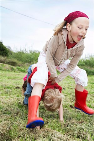 Two children playing leapfrog Stock Photo - Premium Royalty-Free, Code: 649-02199569