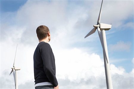 Man looking at wind turbines Stock Photo - Premium Royalty-Free, Code: 649-02199579