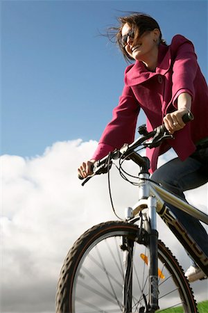 Woman riding a bike Stock Photo - Premium Royalty-Free, Code: 649-02199584