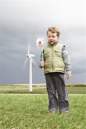 Boy with windmill on a wind farm Stock Photo - Premium Royalty-Free, Code: 649-02199589