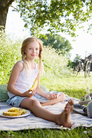 Girl eating pineapple Stock Photo - Premium Royalty-Free, Code: 649-02199696