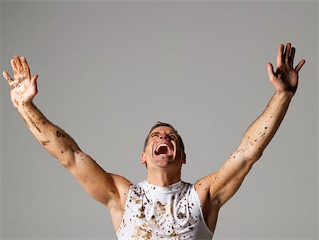 simsearch:614-02613976,k - Joyous mud covered man with arms raised Stock Photo - Premium Royalty-Free, Code: 649-02199779