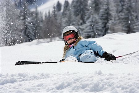 skier falling - Girl with skis lying on snow Stock Photo - Premium Royalty-Free, Code: 649-02290250