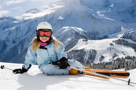 Girl with skis lying on the snow Stock Photo - Premium Royalty-Free, Code: 649-02290251
