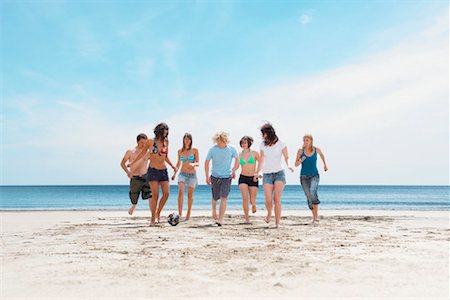 someone playing football kicking the ball - Group playing with ball on beach Stock Photo - Premium Royalty-Free, Code: 649-02290481