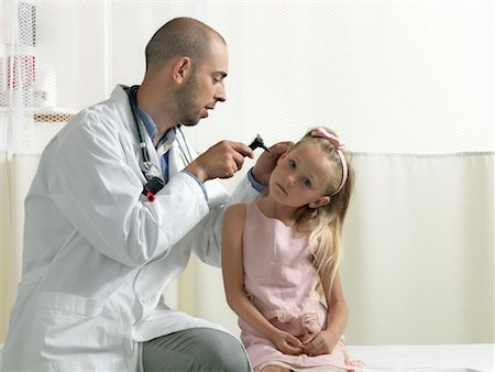 Doctor examining girl Stock Photo - Premium Royalty-Free, Code: 649-02348489