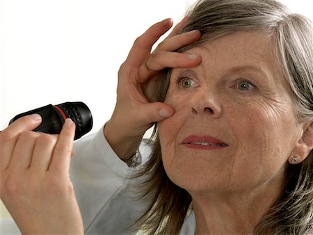 doctor eyes - Doctor examining mature woman Stock Photo - Premium Royalty-Free, Code: 649-02348507