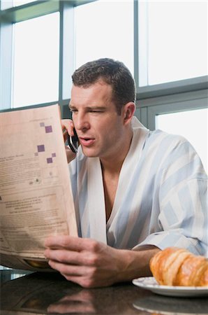 smiling businessman laptop relax indoors - Portrait of a male reading the paper Stock Photo - Premium Royalty-Free, Code: 649-02423460