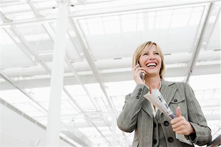 Woman smiling using cell phone Stock Photo - Premium Royalty-Free, Code: 649-02423637