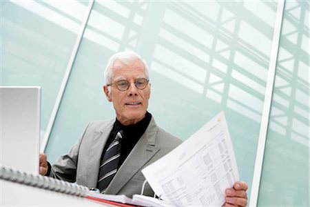 simsearch:649-06829703,k - Older man working looking at papers Stock Photo - Premium Royalty-Free, Code: 649-02423662