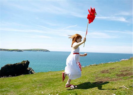 energy windmill hills - Young girl running with windmill Stock Photo - Premium Royalty-Free, Code: 649-02423988