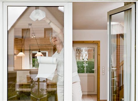 Woman cleaning a window Stock Photo - Premium Royalty-Free, Code: 649-02665390