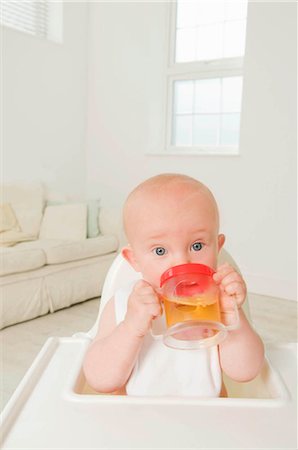 A portrait of a baby drinking juice. Stock Photo - Premium Royalty-Free, Code: 649-02665485
