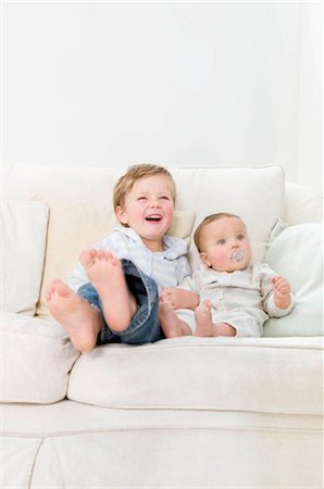 Brothers sitting together on a sofa Stock Photo - Premium Royalty-Free, Code: 649-02665494