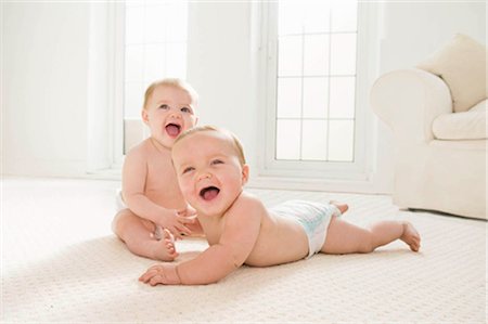 sitting baby diaper - Two babies laughing together. Stock Photo - Premium Royalty-Free, Code: 649-02665501