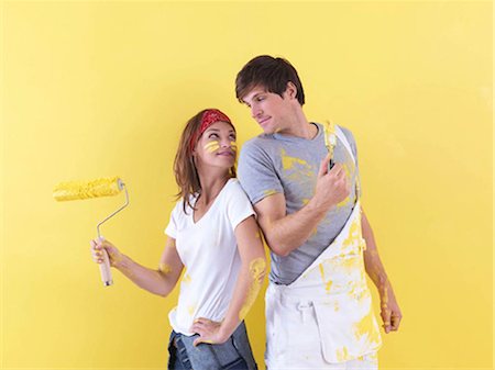 project completion - Couple posing in front of wall. Stock Photo - Premium Royalty-Free, Code: 649-02665686