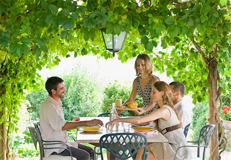 simsearch:649-03771106,k - Group enjoying meal in garden Stock Photo - Premium Royalty-Free, Code: 649-02665914