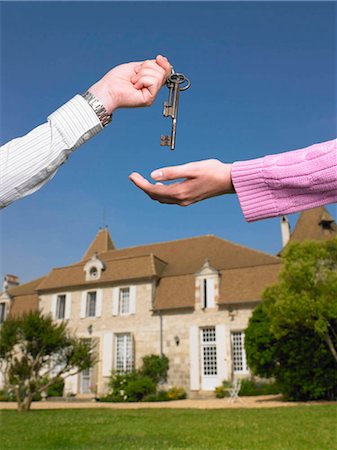 Woman receiving keys to country home Stock Photo - Premium Royalty-Free, Code: 649-02666452
