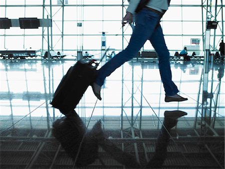 people airports silhouettes - woman running with suitcase Stock Photo - Premium Royalty-Free, Code: 649-02666474