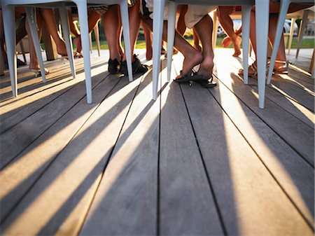 deck summer people not boat - Many legs under table casting shadows Stock Photo - Premium Royalty-Free, Code: 649-02666513