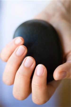 spa stone therapy - Hand holding hot stone Stock Photo - Premium Royalty-Free, Code: 649-02731219