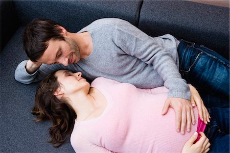 Pregnant woman and man laying on couch Stock Photo - Premium Royalty-Free, Code: 649-02731295