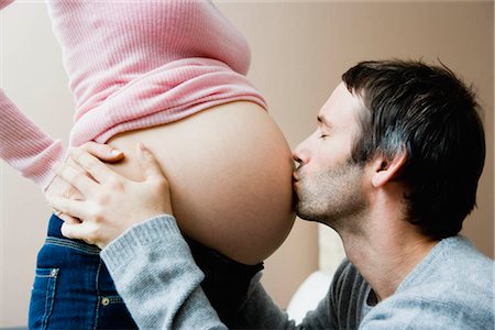 simsearch:649-03796570,k - Man kissing woman's pregnant stomach Stock Photo - Premium Royalty-Free, Code: 649-02731297