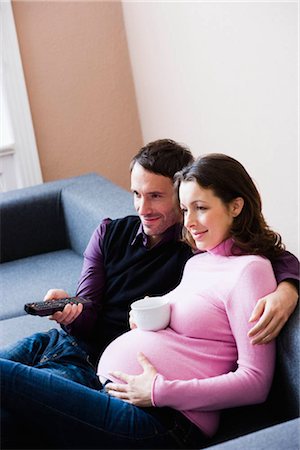 Pregnant woman and man sitting on couch Stock Photo - Premium Royalty-Free, Code: 649-02731301