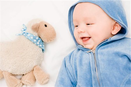 sheep coat - Baby smiling to a sheep Stock Photo - Premium Royalty-Free, Code: 649-02731332